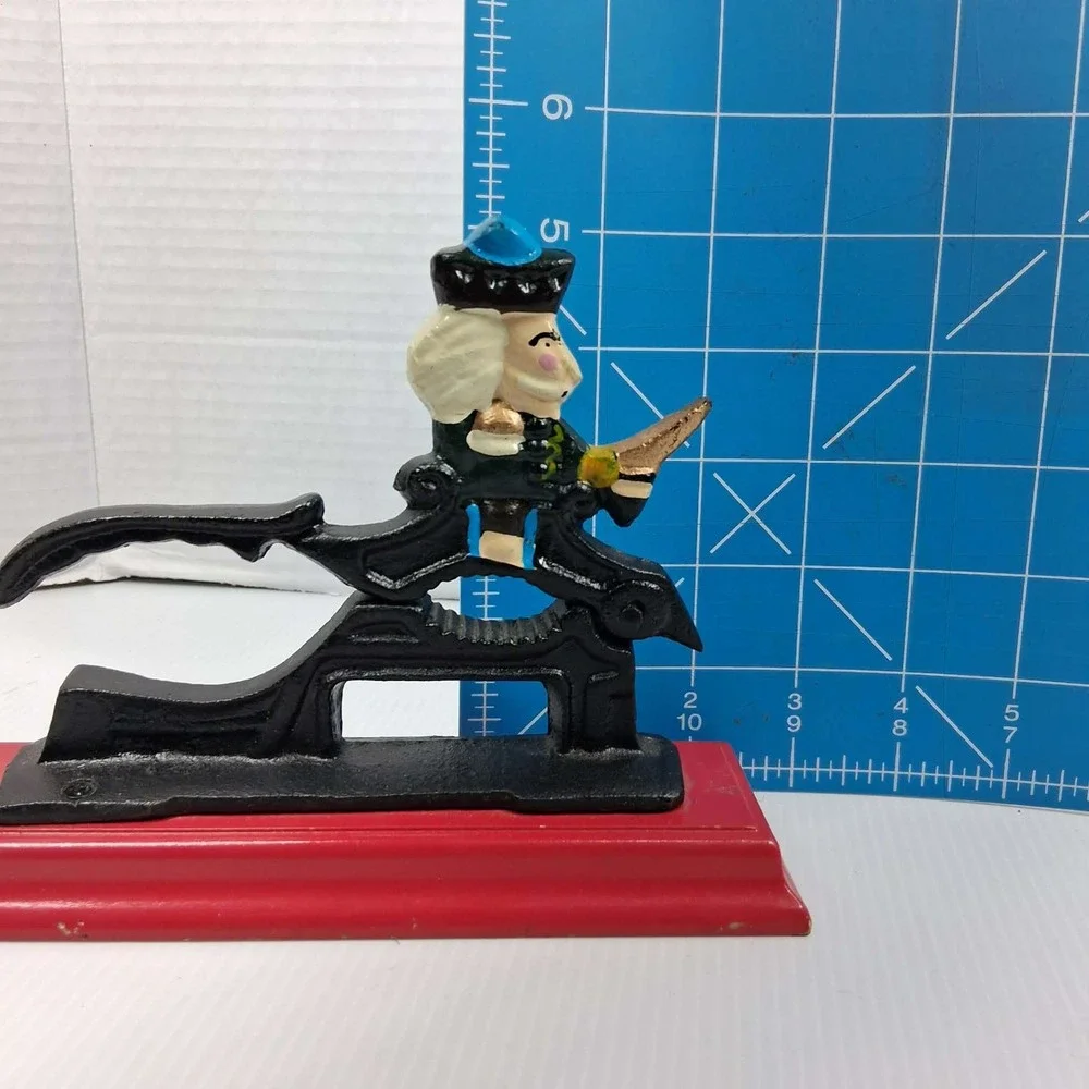 Vintage Cast Iron Mechanical Nutcracker Soldier Figure on Red Wood‎ Base Black